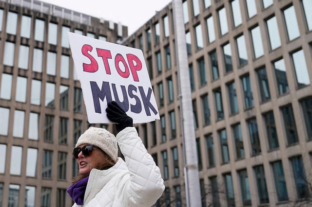 People gather to protest outside the headquarters of the Office of Personnel Management after the Elon Musk-led Department of Government Efficiency was tasked with oversight of OPM, in Washington, Feb. 2, 2025.
