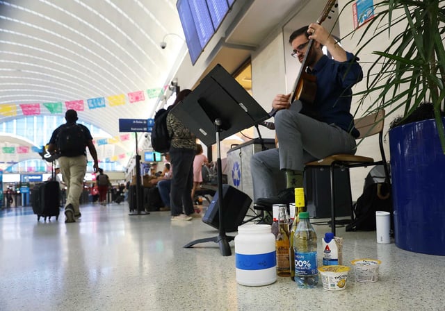 Travelers passing through San Antonio International Airport on Memorial Day weekend in 2023 leave an assortment of gifts for guitarist Owen Graham.