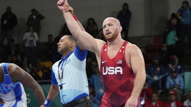 FILE - United States' Kyle Snyder, right, celebrates after winning gold against Cuba's Arturo Silot, left, during the men's 97kg wrestling freestyle final bout at the Pan American Games Santiago, Chile, Nov. 1, 2023. (AP Photo/Matias Delacroix, File)