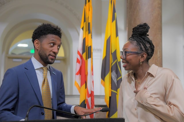 Brandon M. Scott, mayor of Baltimore talks with Rian Hargrave, founder of Onyx Development during a press conference at City Hall, regarding the announcement of Baltimore’s intent on passing the Housing Options and Opportunity Act. (Karl Merton Ferron/Staff)