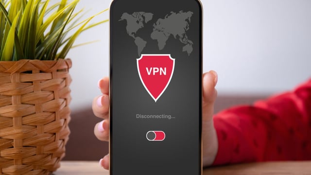 hand holding phone with VPN app that says "disconnected" on the screen