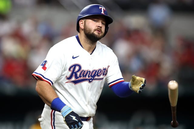 Apr 29, 2025; Arlington, Texas, USA; Texas Rangers first base Jake Burger (21) tosses his bat after being hit by a pitch during the second inning against the Oakland Athletics at Globe Life Field. Mandatory Credit: Tim Heitman-Imagn Images/File Photo