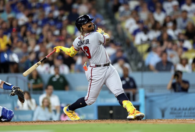 LOS ANGELES, CALIFORNIA - AUGUST 31: Ronald Acuna Jr. #13 of the Atlanta Braves hits a grand slam home run against starting pitcher Lance Lynn #35 of the Los Angeles Dodgers during the second inning at Dodger Stadium on August 31, 2023 in Los Angeles, California.