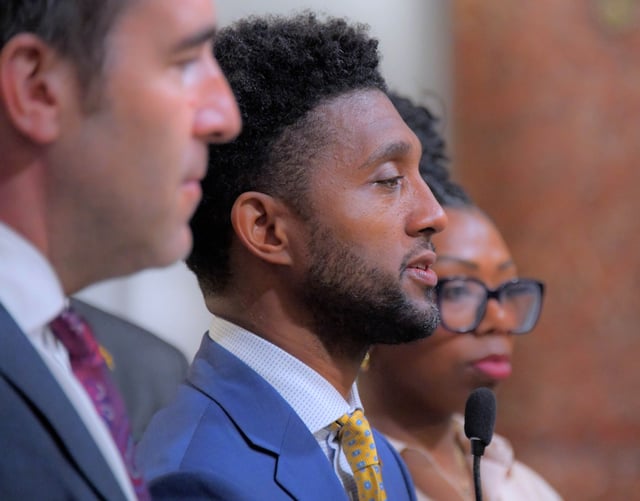 Brandon M. Scott, mayor of Baltimore is flanked by Zeke Cohen, president of Baltimore’s city council, left and Rian Hargrave, founder of Onyx Development during a press conference at City Hall, regarding the announcement of Baltimore’s intent on passing the Housing Options and Opportunity Act. (Karl Merton Ferron/Staff)