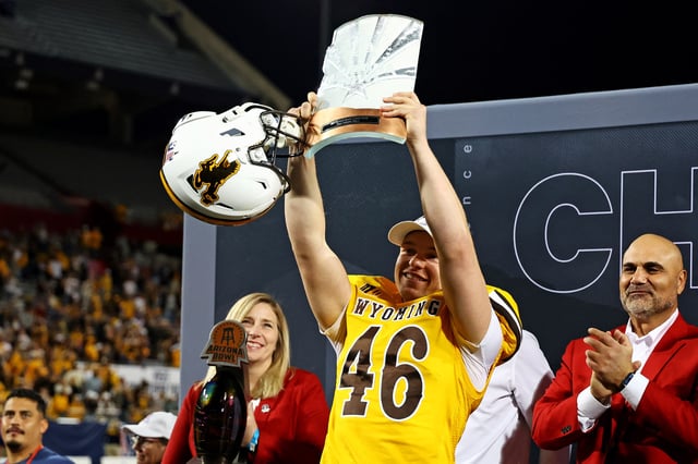 Dec 30, 2023; Tucson, AZ, USA; Wyoming Cowboys place kicker John Hoyland (46) celebrates with offensive MVP trophy after the Wyoming Cowboys beat the Toledo Rockets in the Arizona Bowl at Arizona Stadium. Mandatory Credit: Mark J. Rebilas-USA TODAY Sports/File Photo