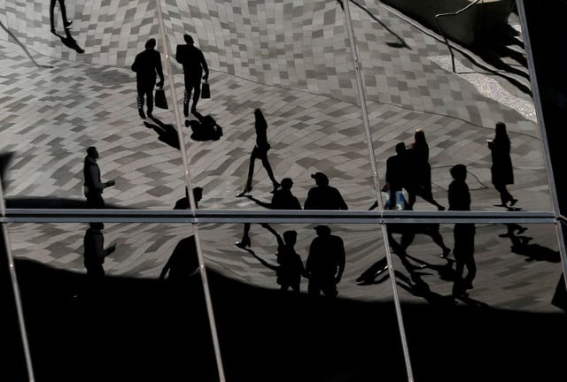 Workers are reflected in an office building's windows in Sydney's Barangaroo business district in Australia's largest city, May 8, 2017.  REUTERS/Jason Reed//File Photo