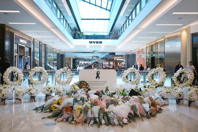 SYDNEY, AUSTRALIA - APRIL 19: Floral tributes are seen at a memorial site during the re-opening of the Westfield Bondi Junction shopping centre on April 19, 2024 in Sydney, Australia. The Westfield Bondi Junction shopping centre re-opened for business on Friday following a stabbing attack on April 13, 2024 that killed seven, including the offender.  (Photo by Lisa Maree Williams/Getty Images)