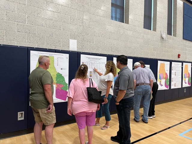 Residents review Baltimore County’s proposed redistricting maps. (Natalie Jones/Staff)