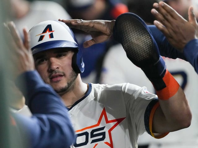 Houston Astros catcher Yainer Diaz (21) is congratulated in the dugout after scoring off of a hit by Houston Astros outfielder Jake Meyers (6) at Daikin Park in Houston on Monday, May 12, 2025.