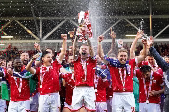 WREXHAM, WALES - APRIL 26: James McClean of Wrexham lifts the trophy alongside teammates as they celebrate their side&#39;s promotion to the Sky Bet Championship after the Sky Bet League One match between Wrexham AFC and Charlton Athletic FC at Racecourse Ground on April 26, 2025 in Wrexham, Wales. (Photo by Kya Banasko/Getty Images)