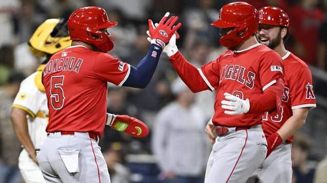 Angels slugger Taylor Ward, right, is congratulated by Yoan Moncada after hitting a grand slam during the ninth inning of Monday’s 9-5 victory over the Padres.