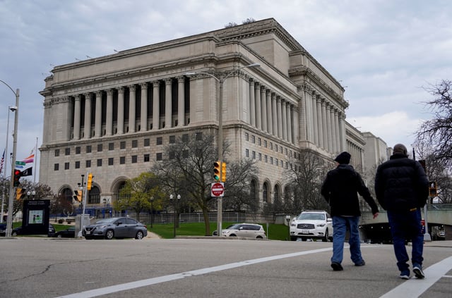 People walk outside Milwaukee County Courthouse, after Wisconsin county judge Hannah Dugan was arrested by U.S. officials, charging her with helping a man in her court evade immigration authorities in an escalating dispute between President Donald Trump's administration and local officials over immigration enforcement, in Milwaukee, Wisconsin, U.S., April 25, 2025.  REUTERS/Vincent Alban/File Photo