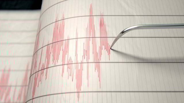 File photo. A seismograph machine needle drawing a line depicting seismic and earthquake activity.