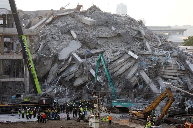 Rescue personnel work at the site of a building that collapsed, following a strong earthquake, in Bangkok, Thailand, March 29, 2025. REUTERS/Patipat Janthong/File Photo