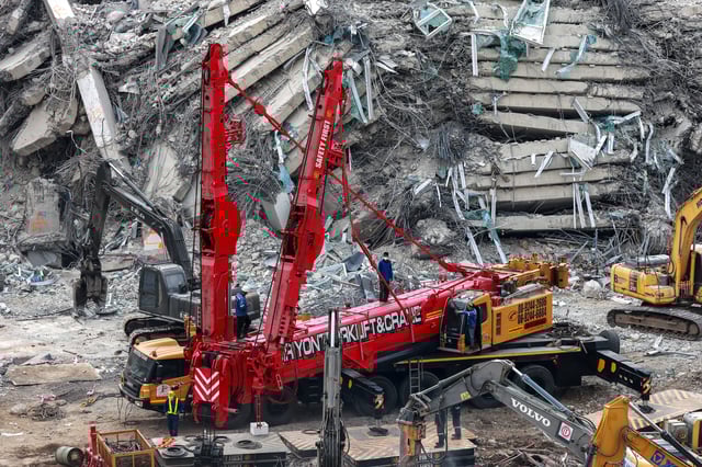 Rescue workers operate with heavy equipment at the site of a collapsed building, following a strong earthquake, in Bangkok, Thailand, April 2, 2025. REUTERS/Athit Perawongmetha/File Photo