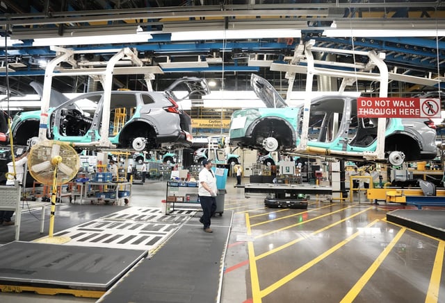 Honda employees work along the vehicle assembly line before an event announcing plans for a Honda electric vehicle battery plant in Alliston, Ont., on Thursday, April 25, 2024. THE CANADIAN PRESS/Nathan Denette