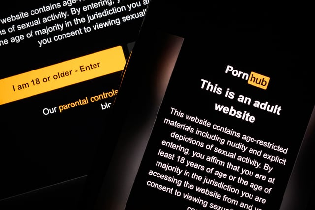 The age-restriction warning screen of the website PornHub is displayed on two digital screens, on January 16, 2025 in London, England.