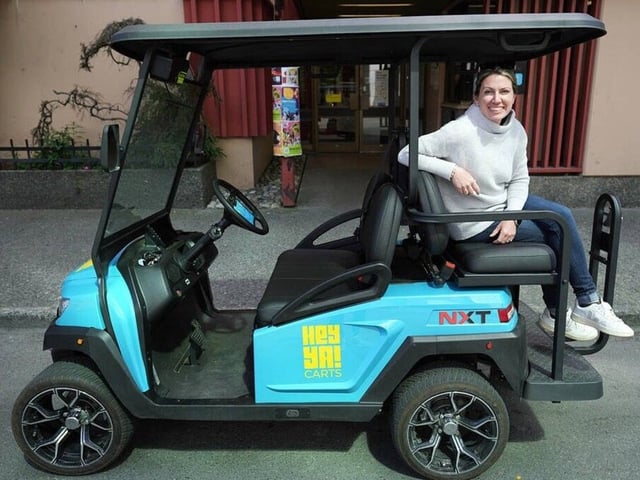 Tasha Maynard, owner of HeyYa! Carts, sits on the back of one of her street-legal golf carts on View Street in Victoria on Monday. ADRIAN LAM, TIMES COLONIST