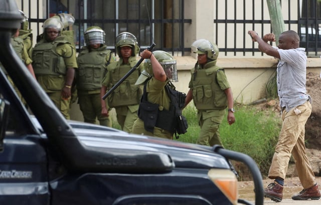 A supporter of Tanzania opposition leader and former presidential candidate of CHADEMA party Tundu Lissu, reacts near riot police officers, near the Kisutu Residents Magistrate Court in Dar es Salaam, Tanzania April 24, 2025. REUTERS/Emmanuel Herman/File Photo
