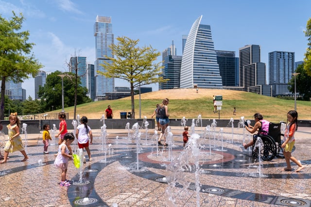 Residents cool off in the Liz Carpenter Splash Pad at Butler Park on July 16, 2023 in Austin, Texas, during a heat wave.