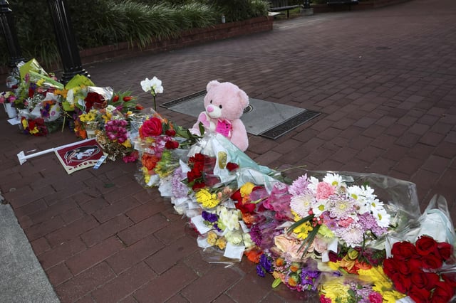 An impromptu memorial of flowers and other items laid near the center of the Florida State campus in sight of the Student Union building, Tallahassee, Fla., Thursday, April 17, 2025. (AP Photo/Gary McCullough)