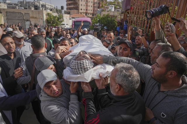 The body of policeman Ahmed Al-Kodra is carried for burial after he was killed in an overnight Israeli army strike on Nasser Hospital in Khan Younis, Gaza Strip, Tuesday, May 13, 2025.(AP Photo/Jehad Alshrafi)