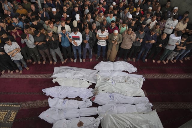 Mourners pray over the bodies of Palestinians killed in an Israeli military airstrike that hit a U.N. school, during a funeral in Jabaliya, northern Gaza Strip, on Monday, May 12, 2025. (AP Photo/Jehad Alshrafi6