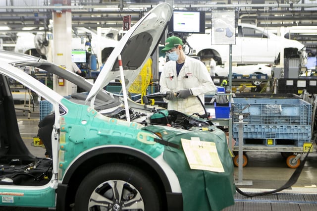 An autoworker stands on the production line for the Honda CRV, at a Honda plant in Alliston, Ont., on Wednesday, March 16, 2022. THE CANADIAN PRESS/Chris Young