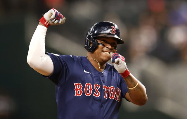 ARLINGTON, TX - AUGUST 02: Rafael Devers #11 of the Boston Red Sox celebrates after hitting a solo home run during the ninth inning at Globe Life Field on August 2, 2024 in Arlington, Texas.