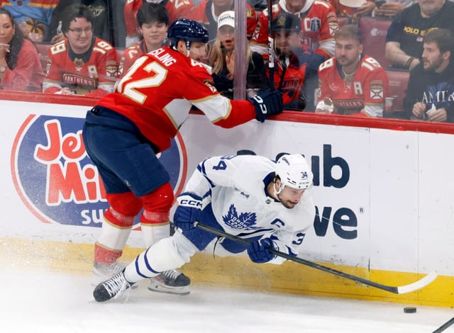 Florida Panthers defenseman Gustav Forsling (42) and Toronto Maple Leafs center Auston Matthews (34) battle on the boards during Game 4 of the second round of the Stanley Cup playoffs on Sunday, May 11, 2025, at Amerant Bank Arena in Sunrise. (Joe Cavaretta/South Florida Sun Sentinel)