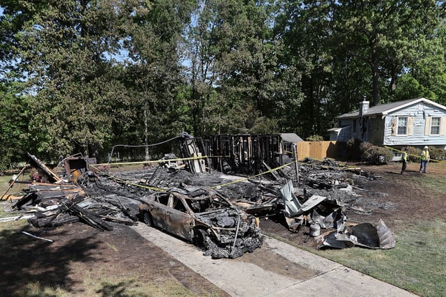 The charred remains of a house after an early morning fire in Washington Township, N.J. on Sunday, May 11, 2025. (David Maialetti/The Philadelphia Inquirer via AP)