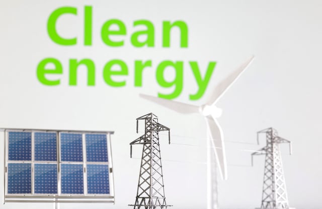 Miniatures of windmill, solar panel and electric pole are seen in front of words Clean energy in this illustration taken January 17, 2023. REUTERS/Dado Ruvic/Illustration