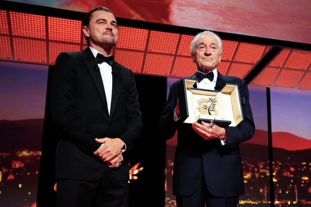 Robert De Niro receives the honorary Palme d’Or from Leonardo DiCaprio during the opening ceremony of the 78th edition of the Cannes Film Festival on May 13, 2025.