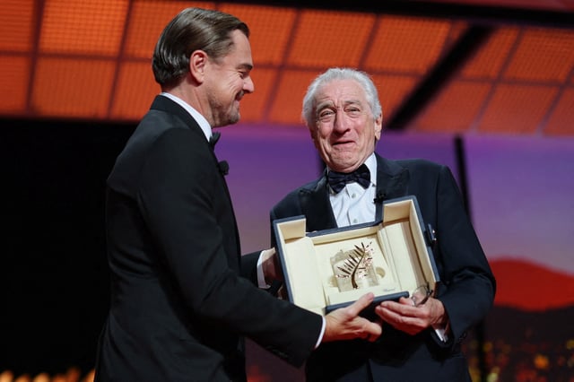 Robert De Niro receives an Honorary Palme d'Or Award from Leonardo DiCaprio during the opening ceremony and the screening the film "Partir un jour" (Leave One Day) Out of competition at the 78th Cannes Film Festival in Cannes, France, May 13, 2025. REUTERS/Stephane Mahe     TPX IMAGES OF THE DAY