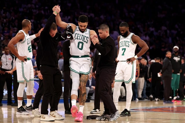 NEW YORK, NEW YORK - MAY 12: Jayson Tatum #0 of the Boston Celtics is assisted off court after being injured against the New York Knicks during the fourth quarter in Game Four of the Eastern Conference Second Round NBA Playoffs at Madison Square Garden on May 12, 2025 in New York City. NOTE TO USER: User expressly acknowledges and agrees that, by downloading and or using this photograph, User is consenting to the terms and conditions of the Getty Images License Agreement. (Photo by Elsa/Getty Images)