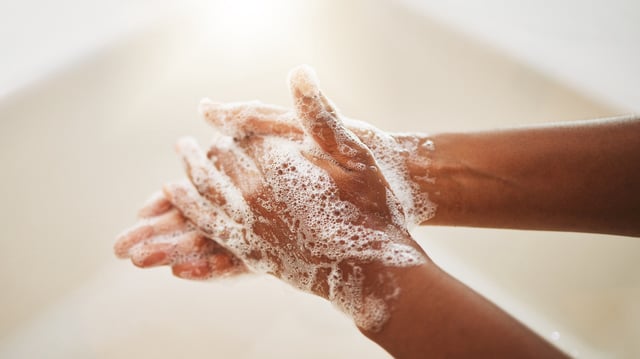 Washing hands with soap and water.