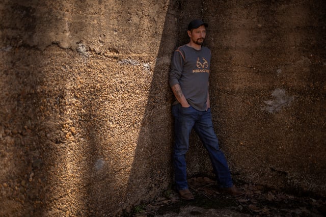 A miner diagnosed with advanced black lung diease, stands inside an old water well near his home in Hinton, West Virginia, U.S., April 13, 2025. REUTERS/Adrees Latif/File Photo