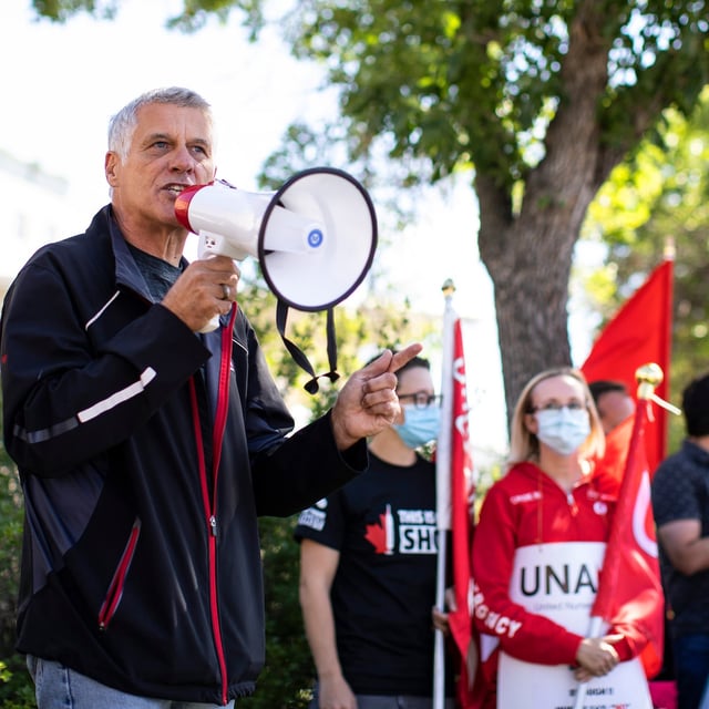Alberta Union of Provincial Employees president Guy Smith speaks during a rally in front of the Royal Alexandra Hospital in Edmonton, Wednesday, Aug. 11, 2021. The union representing thousands of Alberta government workers has voted overwhelmingly in favour of strike action. THE CANADIAN PRESS/Jason Franson