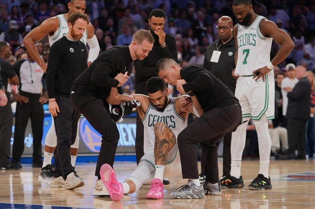 Trainers help the Celtics’ Jayson Tatum off the court after he was injured during the second half of Game 4 in the Eastern Conference semifinals against the Knicks on Monday, May 12, 2025, in New York. (AP Photo/Frank Franklin II)