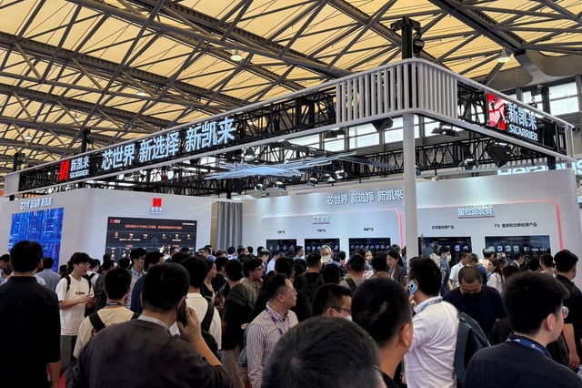 Visitors walk past the SiCarrier booth during SEMICON China, a trade fair for the semiconductor industry, in Shanghai, China March 26, 2025. REUTERS/Che Pan/File Photo