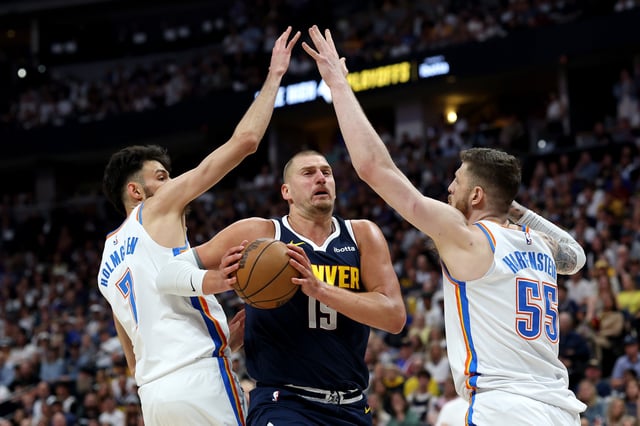 Nikola Jokic #15 of the Denver Nuggets handles the ball as Chet Holmgren #7 and Isaiah Hartenstein #55 of the Oklahoma City Thunder defend during the first quarter in Game Four of the Western Conference Second Round NBA Playoffs at Ball Arena on May 11, 2025 in Denver, Colorado.