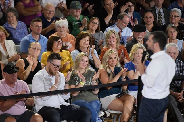 The audience applauds for former Secretary of Transportation Pete Buttigieg.
