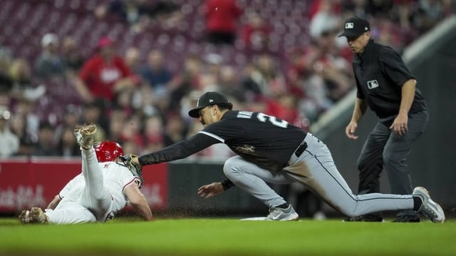 May 13, 2025; Cincinnati, Ohio, USA;  Cincinnati Reds first baseman Spencer Steer (7) is tagged out by Chicago White Sox third baseman Miguel Vargas (20) at third base in the fifth inning at Great American Ball Park. Mandatory Credit: Aaron Doster-Imagn Images