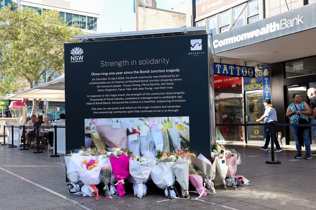 SYDNEY, AUSTRALIA - APRIL 13: Floral tributes are left in front of commemorative display boards on the first anniversary of the Bondi Junction attack at Oxford Street Mall at Westfield Bondi Junction in Sydney, Australia on April 13, 2025 in Sydney, Australia. This Sunday marks the one-year anniversary of the tragic Westfield Bondi Junction attack, which claimed six lives and injured twelve others. The NSW Government, Waverley Council, and Scentre Group are commemorating the event with reflective displays in Oxford Street Mall and support services for those affected. (Photo by Izhar Khan/Getty Images)
