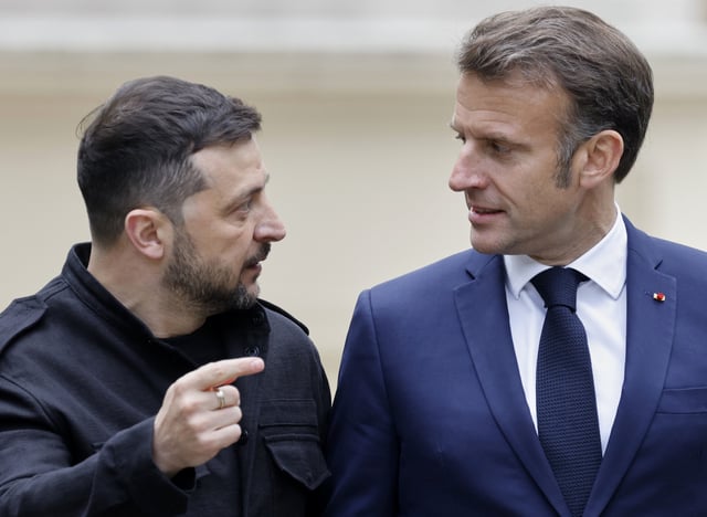 Ukranian President Voloydmyr Zelenskyy, left, talks to French President Emmanuel Macron after a press conference at the Mariynsky Palace in Kyiv, Ukraine, Saturday, May 10, 2025. (Ludovic Marin, Pool Photo via AP)