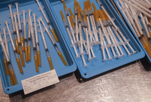FILE - Syringes with the Pfizer vaccine against COVID-19 disease are ready at a new vaccination center in Paris, Thursday, May 6, 2021. (AP Photo/Michel Euler, File)