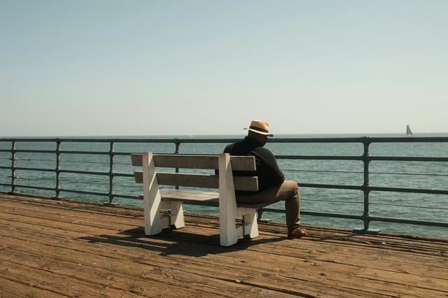 A man sat on a bench in Santa Monica, United States
