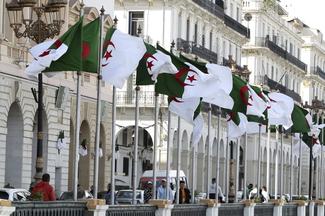 FILE - Algeria's flags fly Wednesday, April 16, 2025 in Algiers. (AP Photo/Fateh Guidoum, File)