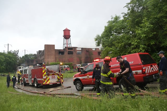 Firefighters were still on the scene of a fire at a multistory mattress warehouse at the intersection of Edmondson Avenue and North Bentalou Street in Baltimore. (Kim Hairston/Staff)