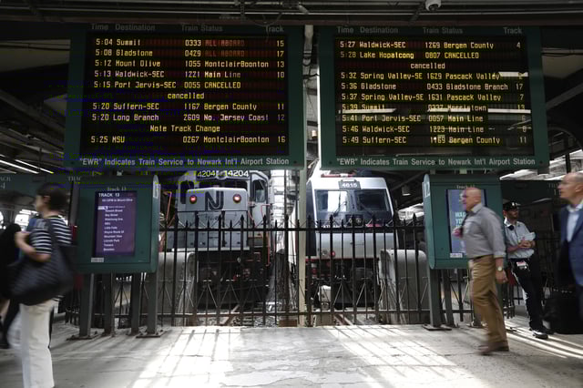 FILe - People head to trains at the New Jersey Transit station in Hoboken, N.J., on Tuesday, Aug. 7, 2018. (AP Photo/David Boe, File)